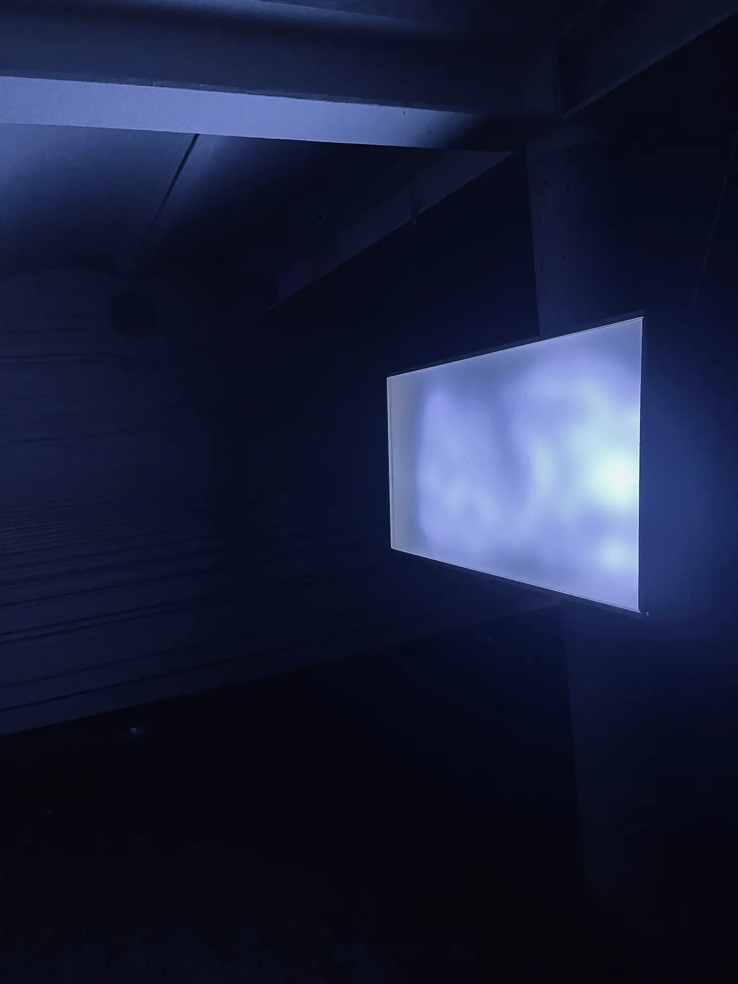 The LED panel glowing on a dark wall.