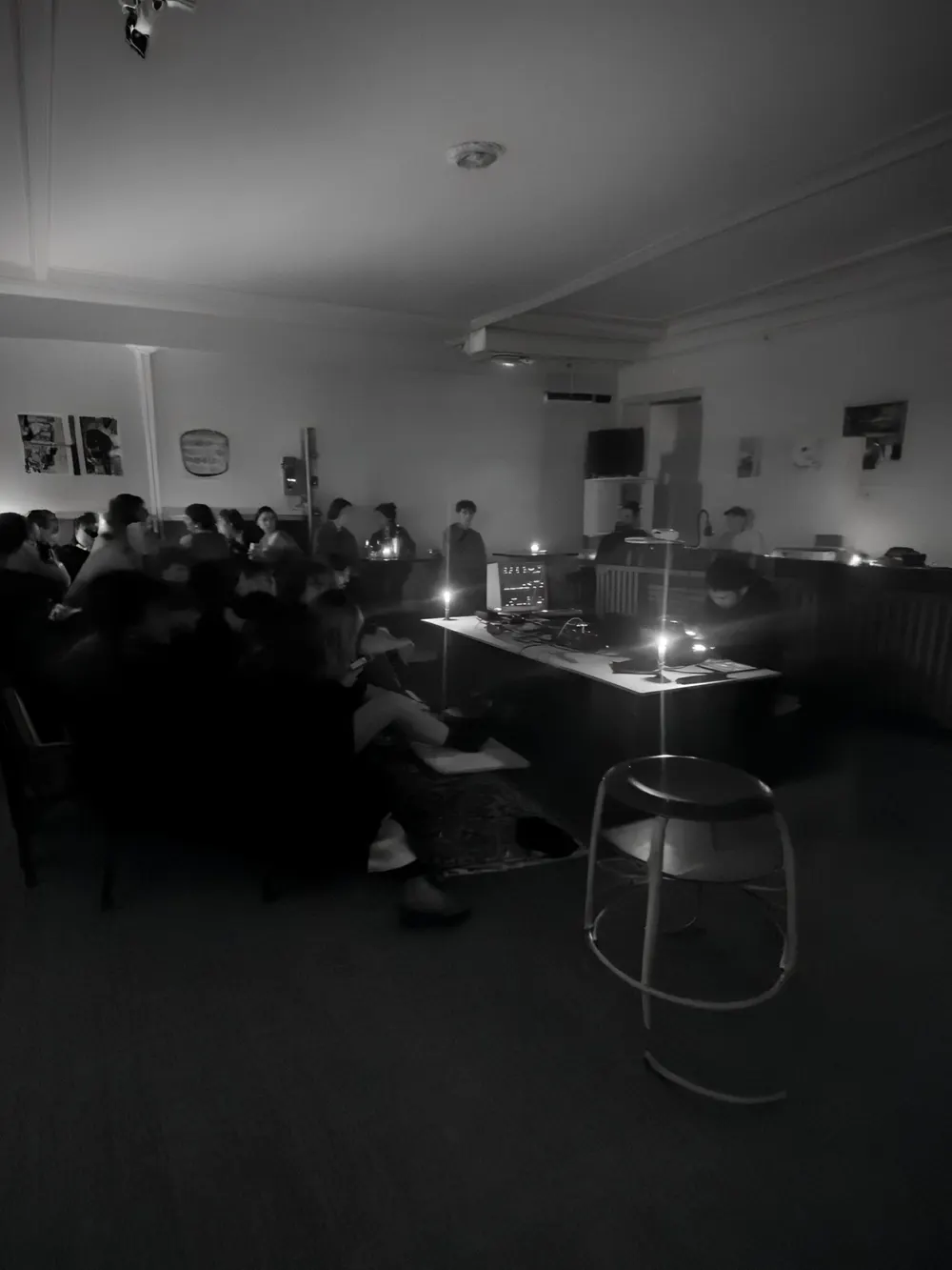 Black-and-white photo of an audience gathered around a quadraphonic performance.