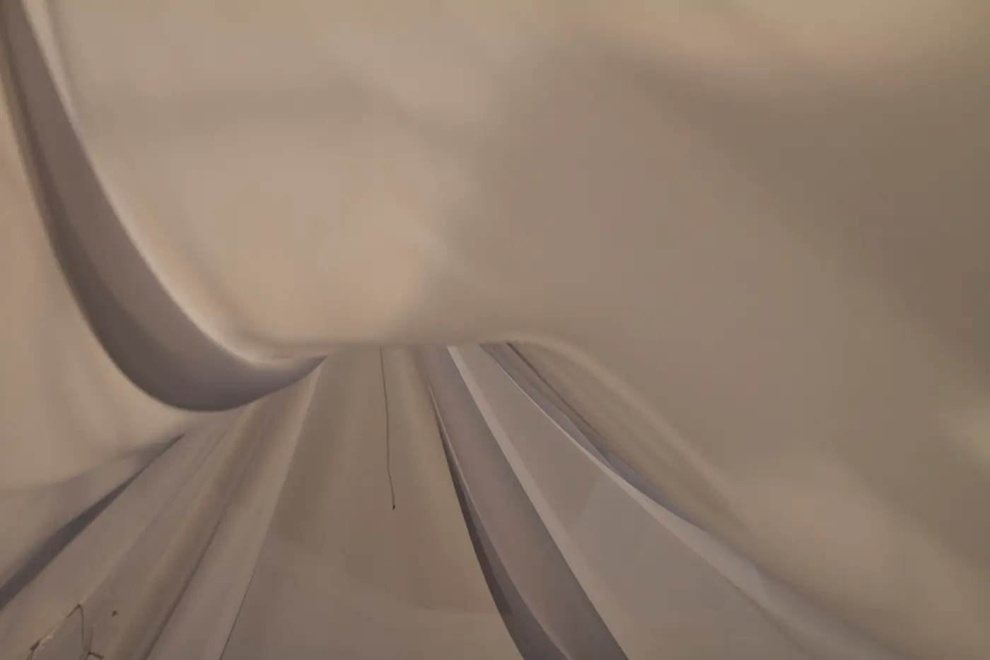 Close-up of translucent synthetic fabric folding in warm light.